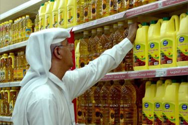 An Emirati man checks out bottles of cooking oil in a supermarket in Dubai on July 19, 2008.