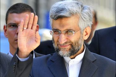 afp :Iran's top nuclear negotiator Said Jalili gestures as he walks back in Geneva's old town street with his delegation after a meal during talks on Tehran's nuclear programm on