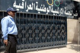 afp : A security member stands guard at the entrance to the National Olympic Council of Iraq building in Baghdad on July 26, 2008. A glimmer of hope that Iraqi athletes could be