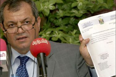 afp : Hussein Saeed, President of the Iraqi Football Union, holds up a copy of a letter from the Iraqi government sent to FIFA regarding the government's non-interference in the