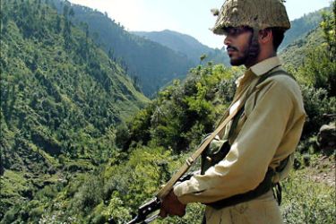 f_In this picture taken on October 17, 2002, A Pakistani trooper patrols at the Line of Control (LOC) - the defacto border between nuclear capable neighbours