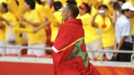 Jaouad Gharib of Morocco is draped in his national flag after finishing second in the men's marathon of the athletics competition in the National Stadium during the Beijing