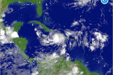 AFP / This August 27, 2008 NOAA color enhanced satellite image shows Tropical Storm Gustav located southeast of Guantanamo, Cuba. Tropical Storm Gustav stalled over Haiti