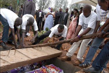 epa : epa01431870 (FILE) A file picture dated 07 April 2005 showing volunteers laying to rest the remains of victims of the 1994 genocide, in Murambi, eastern Rwanda. The