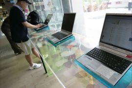 People use computers to surf the internet at the free internet zone for visitors at South Korea's top fixed-line and broadband firm KT Corp in Seoul in this picture taken
