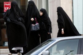 r : Saudi women wait for a car to arrive in Riyadh in this June 9, 2005 file photo. An hour's drive north of Jeddah on the Red Sea coast, 8,000 workers toil under the relentless summer