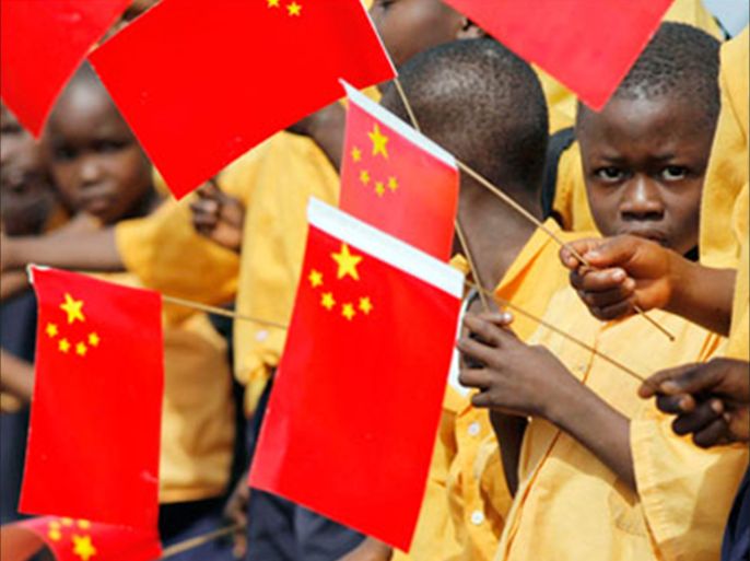 REUTERS/ Liberian children hold Chinese flags before the arrival of China's President Hu Jintao in Monrovia in this February 1, 2007 file photo. A big influx of workers from China is earning