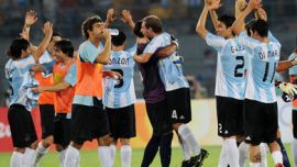 Argentina's players celebrate at the end of the 2008 the Beijing Olympic Games men's semi-final football match Brazil vs. Argentina on August 19, 2008 in Beijing.