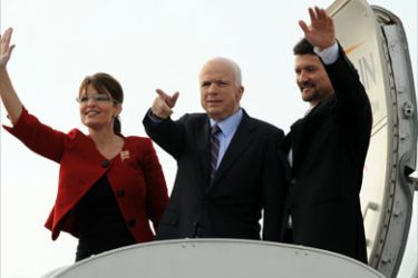 Republican presidential candidate Arizona Senator John McCain (C), his running mate Alaska Governor Sarah Palin (L) and her husband Todd Palin (R) wave as the board the Straight Talk Air campaign plane at the airport in Lancaster, Pennsylvania on September 9, 2008.