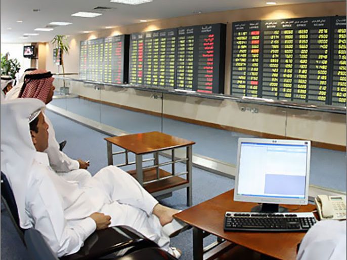 . AFP - Investors follow the stock market activity on monitors at the Doha Securities Market in Doha on September 16, 2008. Global equities tumbled for a second day running today as