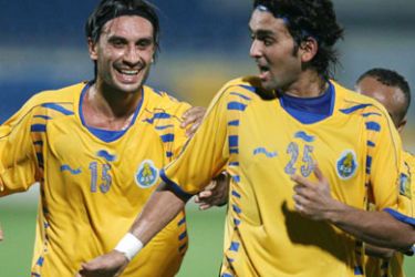 Al-Gharafa's Hakan Yakin (L) of Switzerland celebrates with team mate Nashat Akram after scoring a second goal against Al-Wakrah during their Qatar Stars League soccer