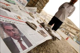 AFP - Headlines with an image of Sunni MP Mithal Alusi are on display at a newspaper stall in central Baghdad on September 15 2008, a day after the Iraqi parliament lifted the
