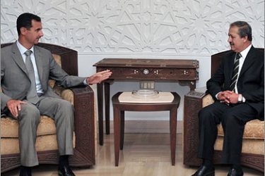 REUTERS/Syria's President Bashar al-Assad (L) talks to the new Syrian ambassador to Iraq Nawaf Fares in Damascus September 16, 2008. Syria named
