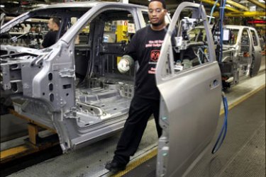 afp : Chrysler LLC employee John Hamilton installs a door on the all new 2009 Dodge Ram as it goes through the assembly line at the Warren Truck Assembly Plant