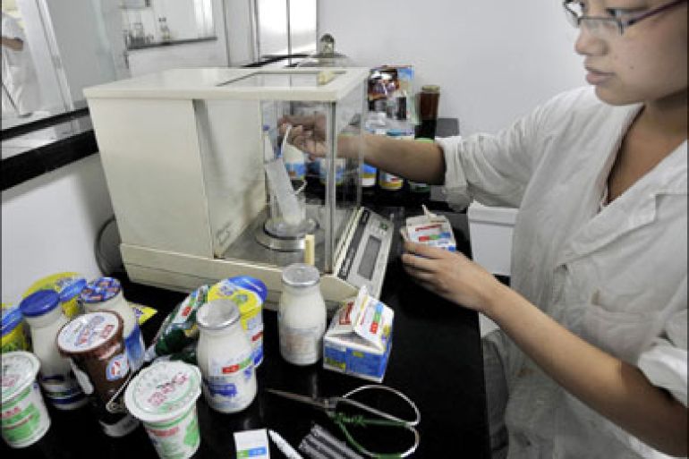 afp : A Chinese lab technician performs tests on the various milk products suspected to be tainted, in Wuhan, central China's Hubei province on September 23, 2008. The