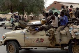 afp : Rebels of the Sudan Liberation Army (SLA), loyal to leader Minni Minawi, ride at the back ofa pick-up truck in El-Fasher, the administrative capital of north Darfur on