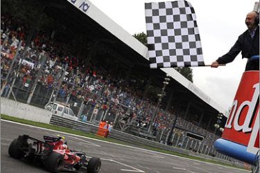 REUTERS/Toro Rosso Formula One driver Sebastian Vettel of Germany crosses finish line to win the Italian F1 Grand Prix race in Monza September