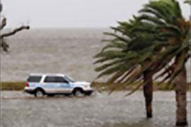 AFP - A police vehicle drives along Lakeshore Drive outside of the Federal Levee system as high winds from Hurricane Ike have pushed water from Lake Pontchatrain ashore on Setember