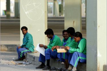 AFP / Asian workers take a break at Friday Market in Kuwait City on September 9, 2008. The Kuwaiti parliament's human rights committee has called for a review of the sponsorship system