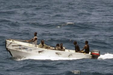 Pirates leave the merchant vessel MV Faina (not shown) for the Somali shore, while under observation by a U.S. Navy ship, in this picture taken on October 8, 2008 and released