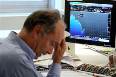afp : A trader reacts as he watches financial markets on a computer, on October 6, 2008 in Paris, at Meesschaert Asset Management. France is not seeking to duck its EU