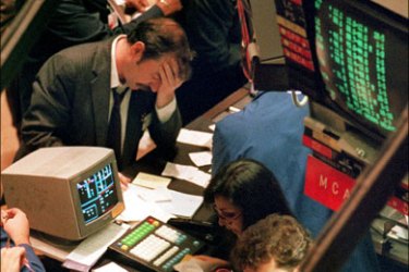 afp : (FILES) A picture taken on October 19, 1987 shows a trader holding his head at the floor of the New York Stock Exchange when the Dow Jones dropped over 500 points, the