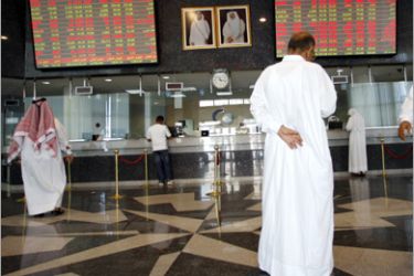 REUTERS / Investors monitor screens showing stock prices at the Doha Securities Market building in Doha October 19, 2008. REUTERS/Fadi Al-Assaad (QATAR)