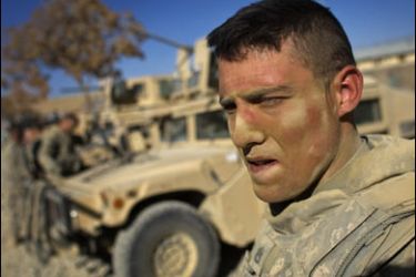 f/A US Army soldier from 1-506 Infantry Division is covered in dust after gunning from the hatch of a humvee on November 29, 2008 in Paktika province,