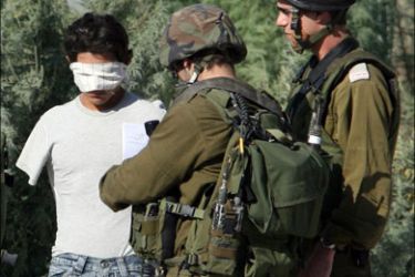 afp : Israeli soldiers detain a blindfolded Palestinian man at the Beit Eiba checkpoint near the West Bank city of Nablus on November 18, 2008. According to an Israeli army