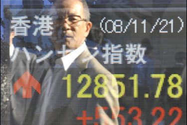f/A businessma is reflected on a share prices board in Tokyo on November 21, 2008.