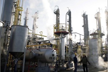 REUTERS / Employees are pictured during the opening ceremony of the Brod oil refinery in Brod November 27 2008. Bosnias sole oil refinery Brod resumed production on Thursday after a three-