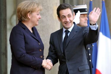 French President Nicolas Sarkozy (R) shakes hands with German Chancellor Angela Merkel upon her arrival, on November 24, 2008