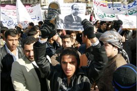 AFP Iraqi protestors hold up a shoe, a picture of Irqaqi Prime Minister Nuri al-Maliki (L) and a picture of Iraqi journalist Muntazar al-Zaidi, who became a