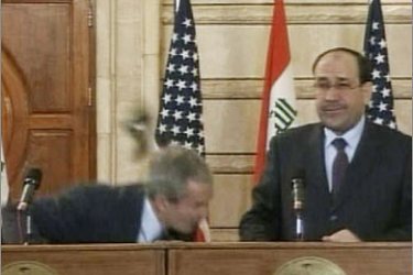 REUTERS/Video frame grab of U.S. President George W. Bush (L) ducking from a shoe during a news conference in Baghdad December 14, 2008. An Iraqi reporter