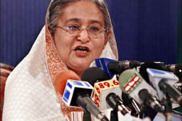r : Bangladesh Awami League President and former prime minister Sheikh Hasina reads her party's election manifesto in Dhaka December 12, 2008. Hasina formally launched on