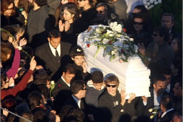 REUTERS / Mourners carry the coffin of Alexandros Grigoropoulos 15 during his funeral in Athens December 9 2008. Riot police fought running battles with hundreds of protesters outside