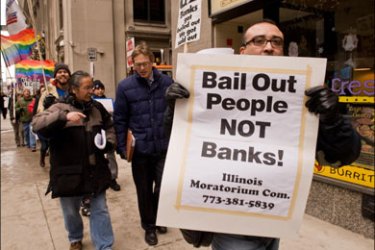 afp : CAPTION CORRECTION - CITYProtesters demonstrate in front of a Bank of America branch in support of Republic Windows & Doors workers December 10, 2008