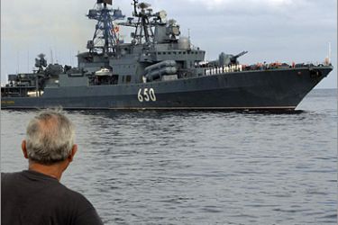 AFP - A person looks at the Russian Admiral Chabanenko destroyer as the ship arrives at Havana's harbor, on December 19, 2008. A group of Russian warships arrived in