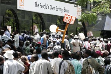 r/People gather to withdraw money from the People's Own Savings Bank (POSB) in central Harare December 5, 2008.