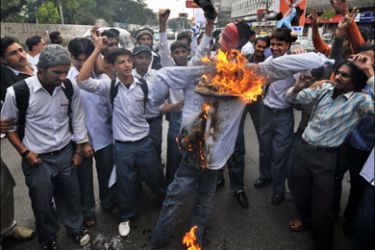 afp : Pakistani activists of Islami Jamiat-e-Tulaba (IJT), a student wing of fundamentalist party Jamaat-i-Islami (JI) burn a shoe adorned effigy of US President George W. Bush in