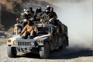 In this file photograph taken on November 26, 2008 Pakistani Taliban militants patrol in the Mamouzai area of Orakzai Agency.