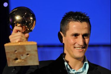 f/Algerian football player Rafik Saifi holds his golden ball award on December 1, 2008 after being named "the best Algerian player for year 2008" during a ceremony organized by the Algerian sport newspaper "Le Buteur" (The scorer), in Algiers