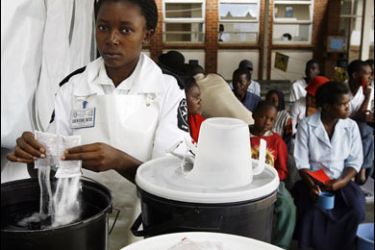 f/A nurse at the Budiriro Polyclinic prepares a sugar solution for patients in Harare on January 29, 2009.
