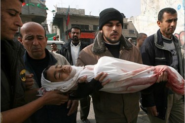 AFP - A man carries the body of a boy killed during Israeli strikes at the Bureij Refugee Camp in central Gaza Strip on January 17, 2009. Israel pummelled Gaza with new strikes on Saturday,