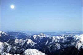 afp : Full moon hangs over the alpine panorama at the Zugspitze peak just before sunrise on January 11, 2009. First mountaineering enthousiasts took the cablecar in the early
