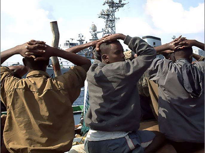REUTERS / Several of the 19 captured Somali pirates, with hands on their heads, are taken to the French naval vessel "Jean de Vienne" which came to the rescue of two cargo ships in the
