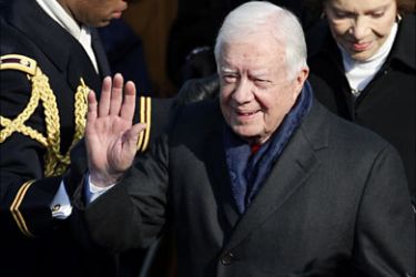 Former U.S. President Jimmy Carter (C) and wife Rosalynn (R) arrive for the inauguration ceremony of Barack Obama as the 44th President of the United States, in Washington