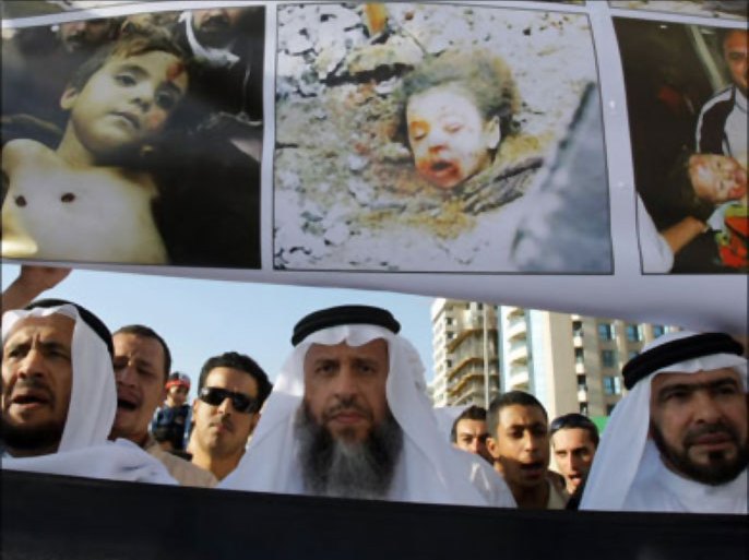 afp : Emirati protestors walk under a banner with pictures of Palestintian victims of Israel's continuing Gaza offensive during a demonstration in the Gulf emirate of Sharjah on