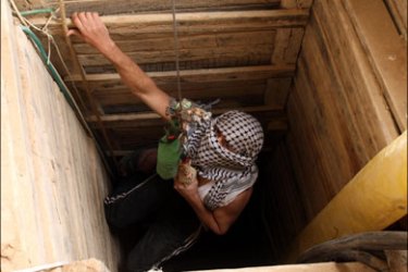 afp : A Palestinian enters a tunnel in the southern Gaza Strip that runs under the Egyptian border and into Gaza at Rafah on January 24, 2009. Israel warned that it could relaunch