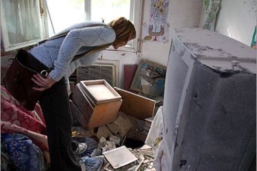 AFP - An Israeli woman checks a hole in a bedroom of a nursing home after a rocket fired from southern Lebanon hit the place in the northern Israeli town of Nahariya on January 8, 2009.